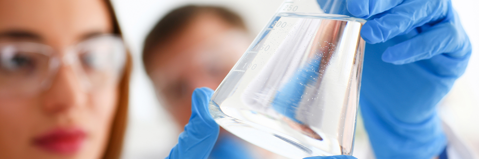 Chemist evaluates the contents of a flask