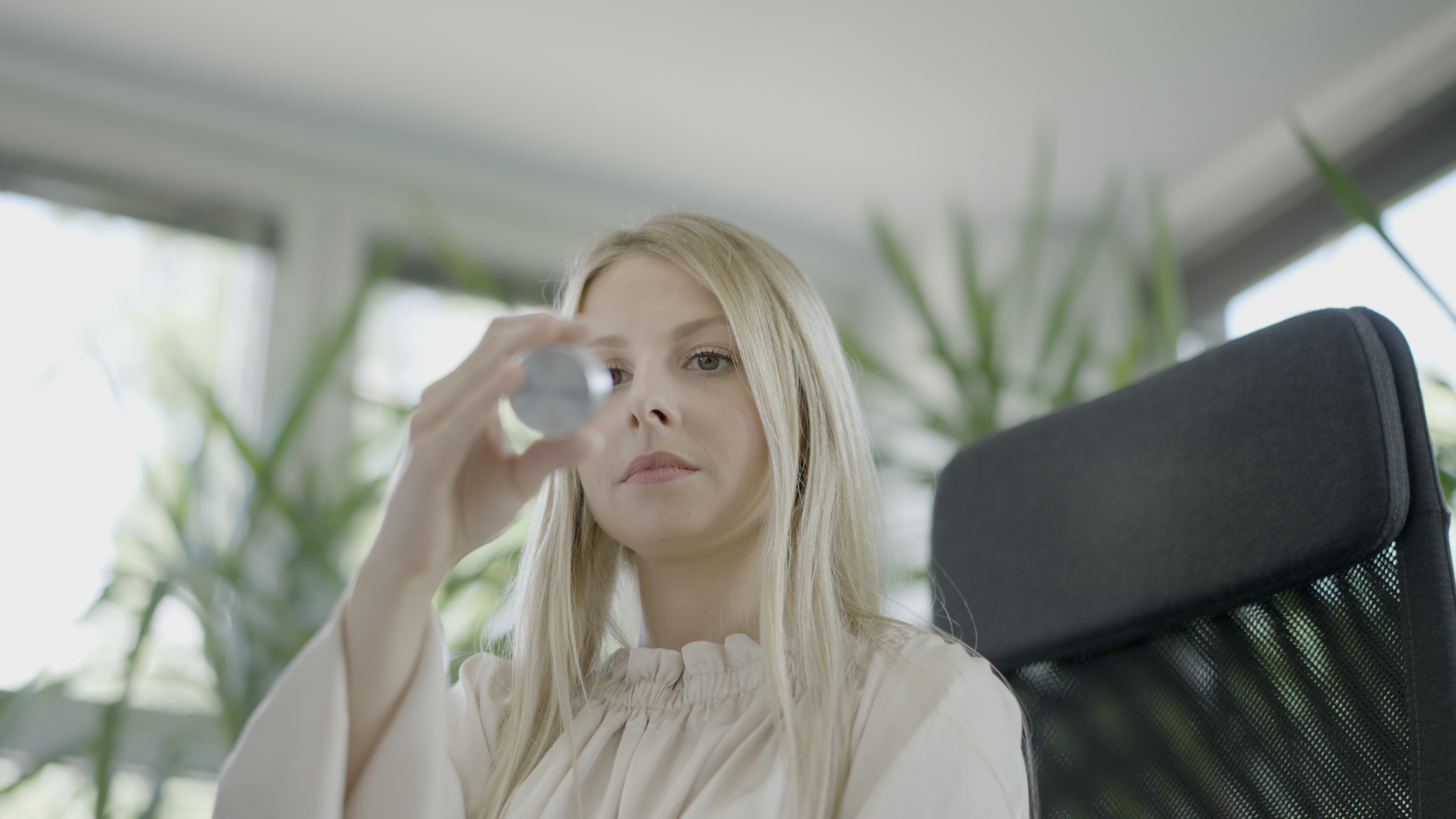 An employee examines a metal reference sample